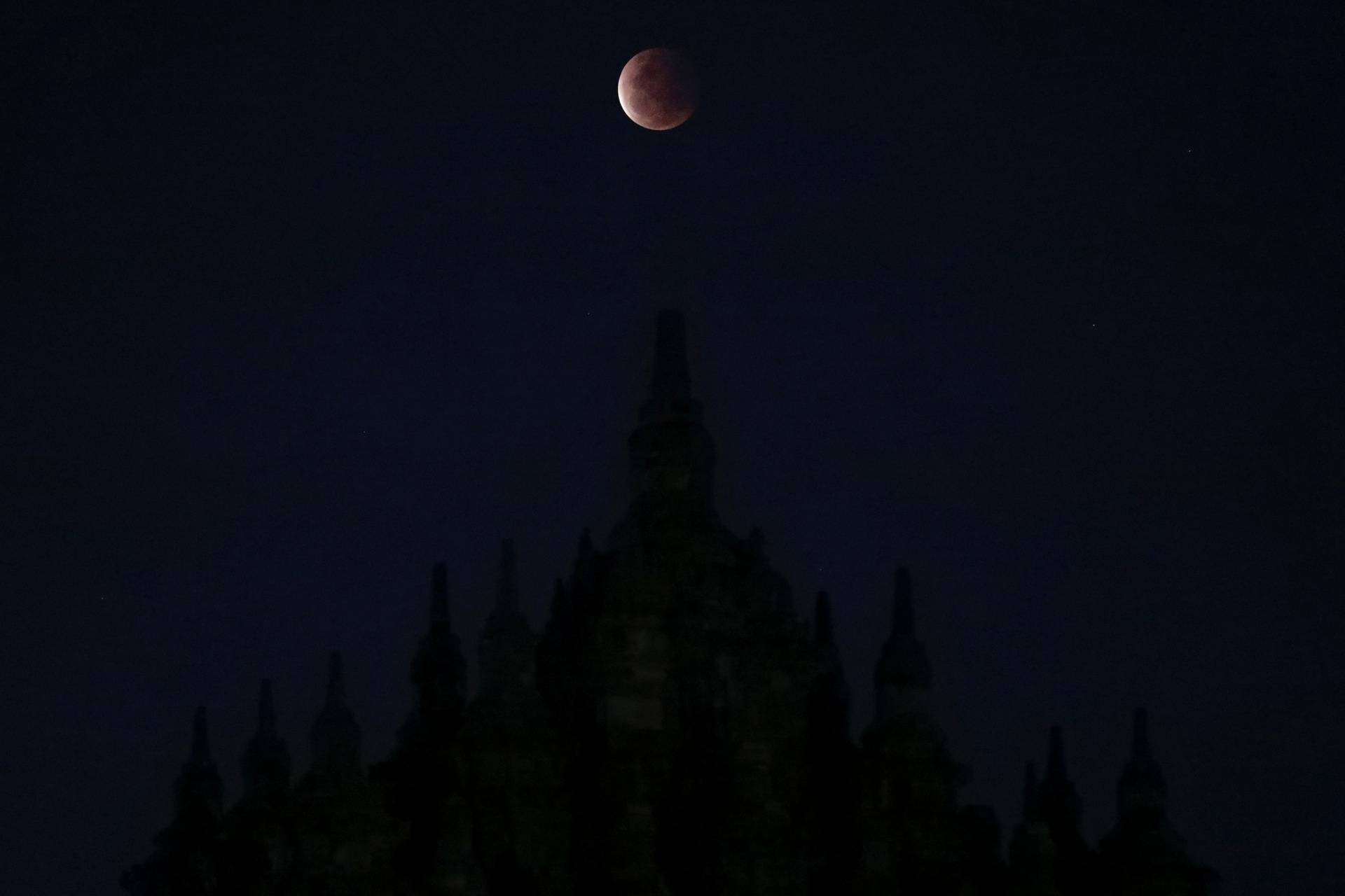 A Super Blood Moon rises over the Plaosan temple during total lunar eclipse in Klaten