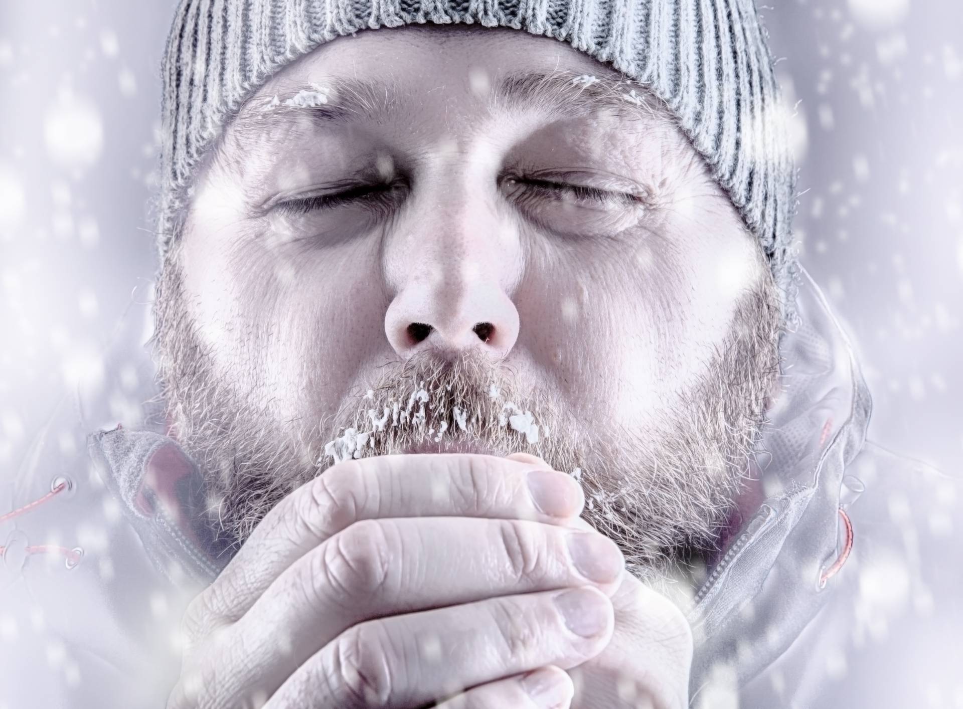 Man freezing in snow storm white out close up