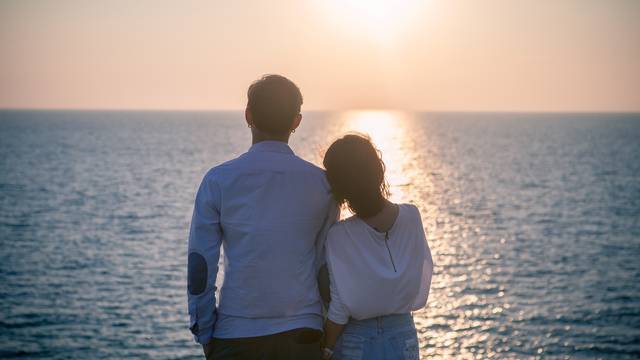 hipster photography style of younger love couples vacation relaxing with sun set sky at destination sea side happiness emotion