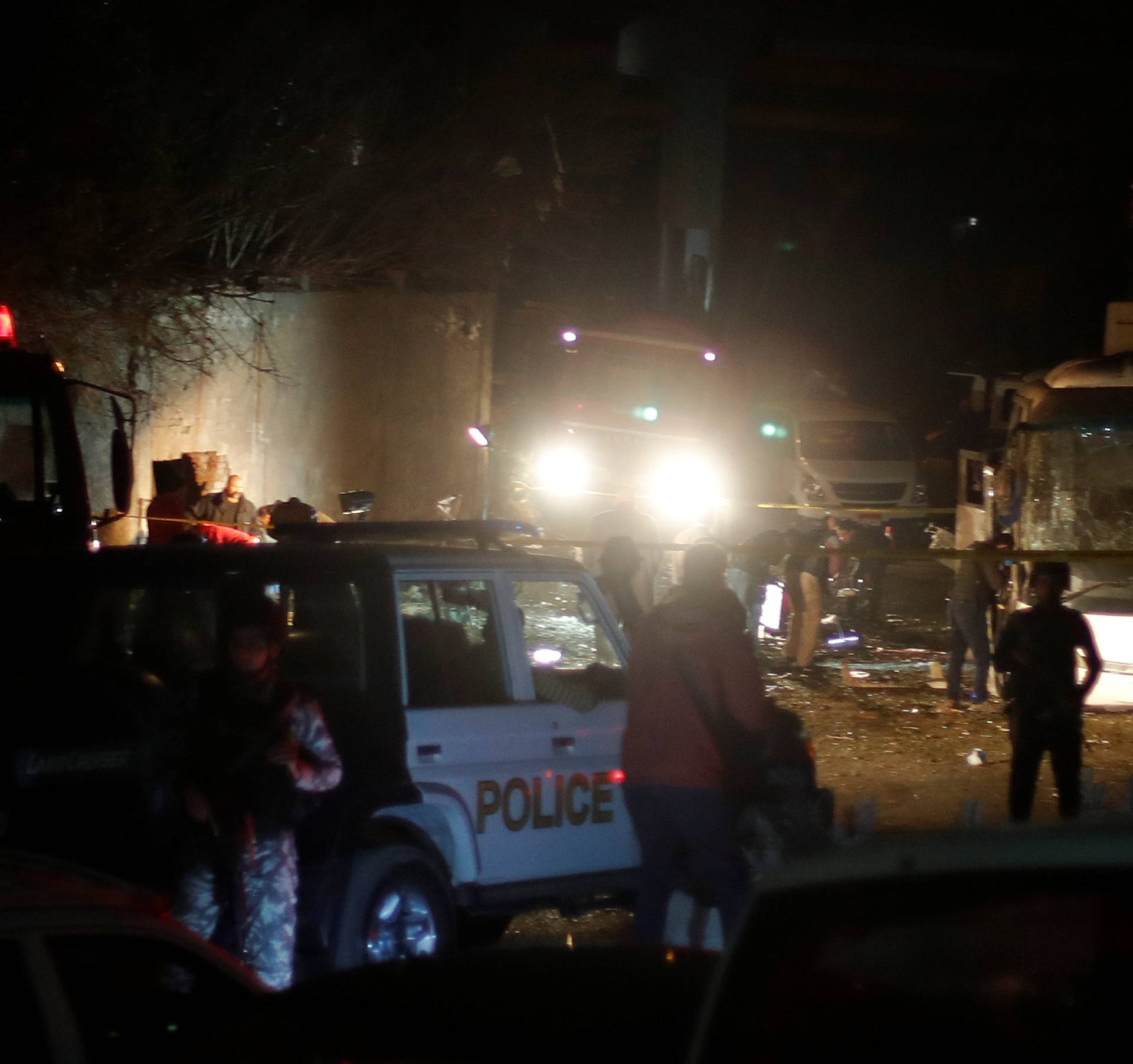Police inspect a scene of a bus blast in Giza