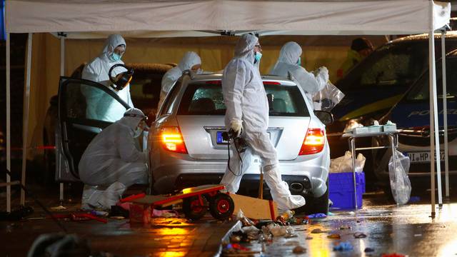 Police forensic officers work at the scene after a car ploughed into a carnival parade injuring several people in Volkmarsen