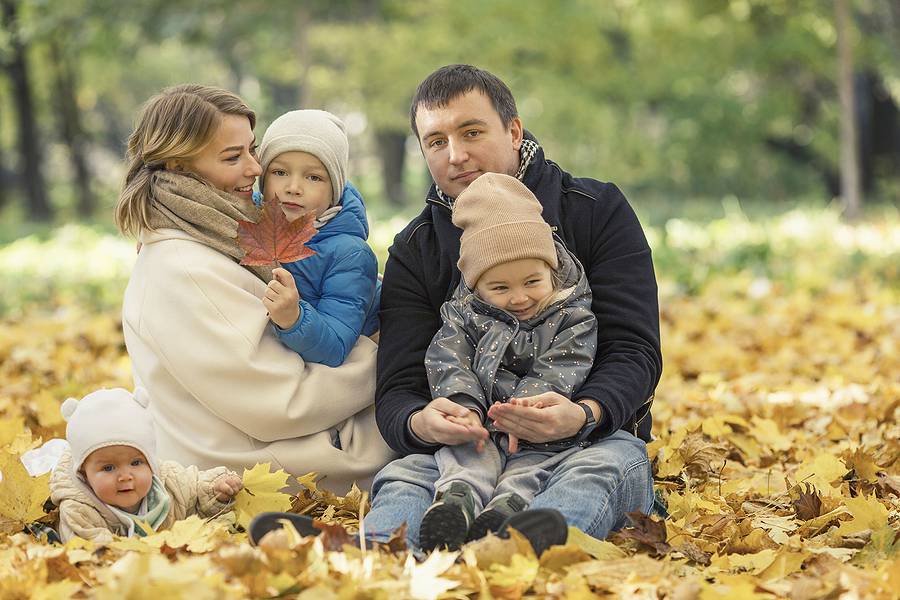 Beautiful Young Family With Children In The Autumn Park. Love An