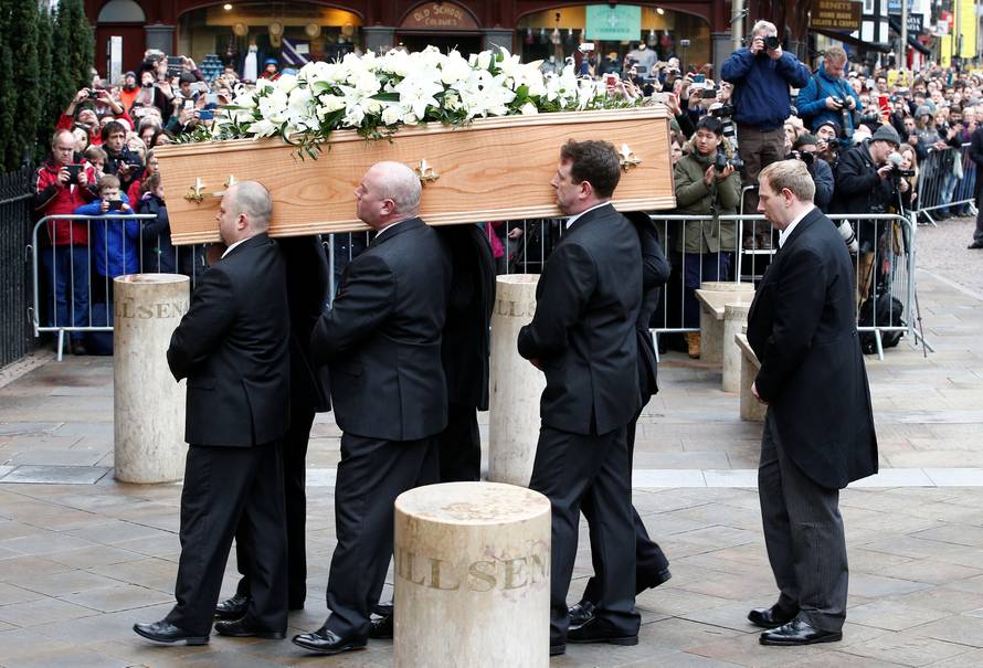 Pallbearers carry the coffin into Great St Marys Church, where the funeral of theoretical physicist Prof Stephen Hawking is being held, in Cambridge