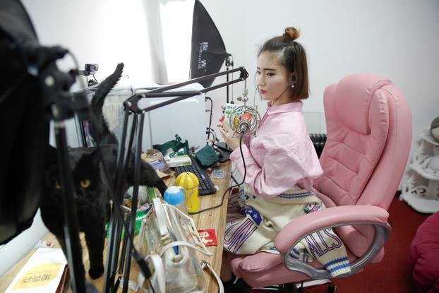 A girl broadcasts at live streaming talent agency Three Minute TV, in Beijing