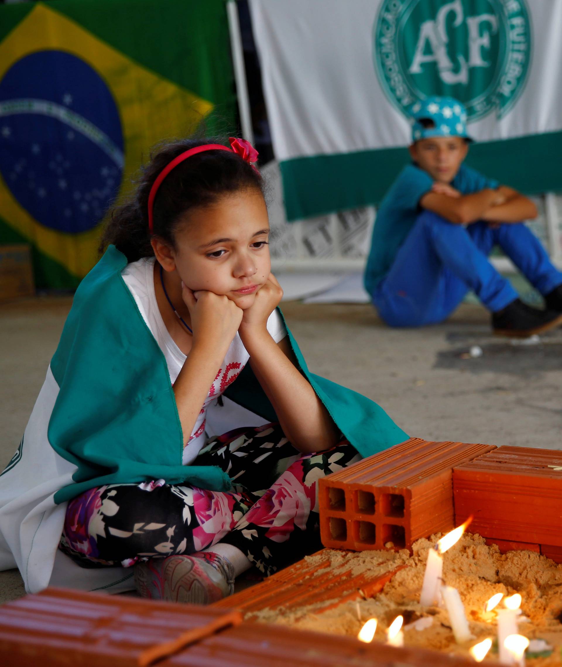 Young fans of Chapecoense soccer team pay tribute to Chapecoense's players at the Arena Conda stadium in Chapeco