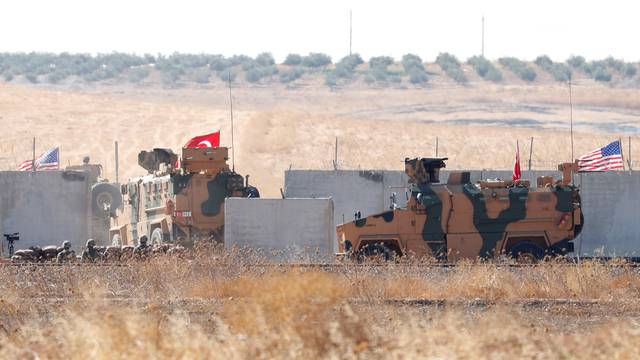 Turkish army vehicles cross into Syria for a joint U.S.-Turkey patrol, near the Turkish town of Akcakale