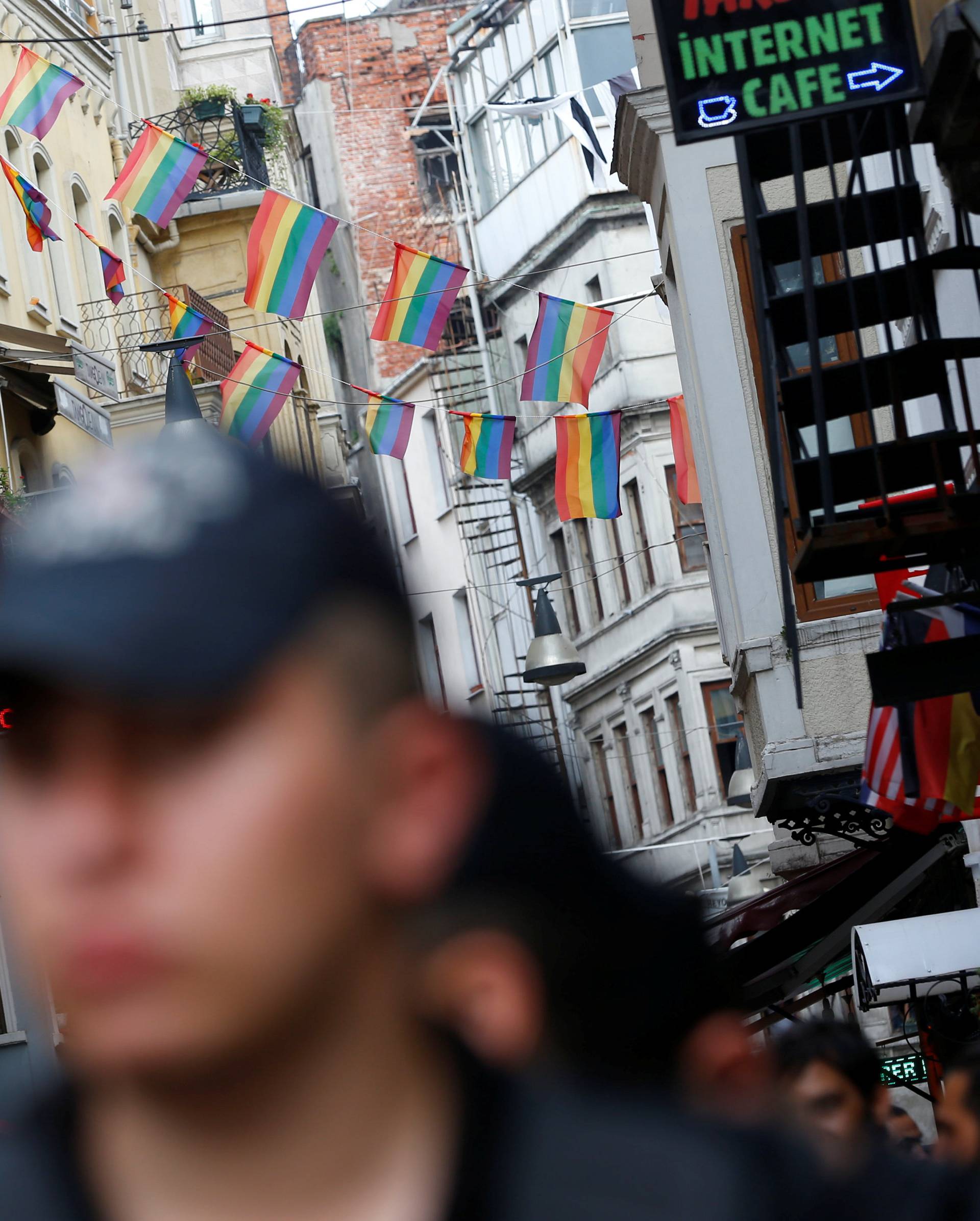 Riot police, with rainbow flags in the background, stands guard at the entrance of a street as LGBT rights activists try to gather for a pride parade, which was banned by the governorship, in Istanbul,