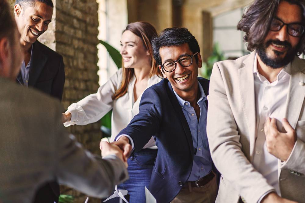 Group,Of,Diverse,Professionals,Celebrating,With,A,Handshake,At,A