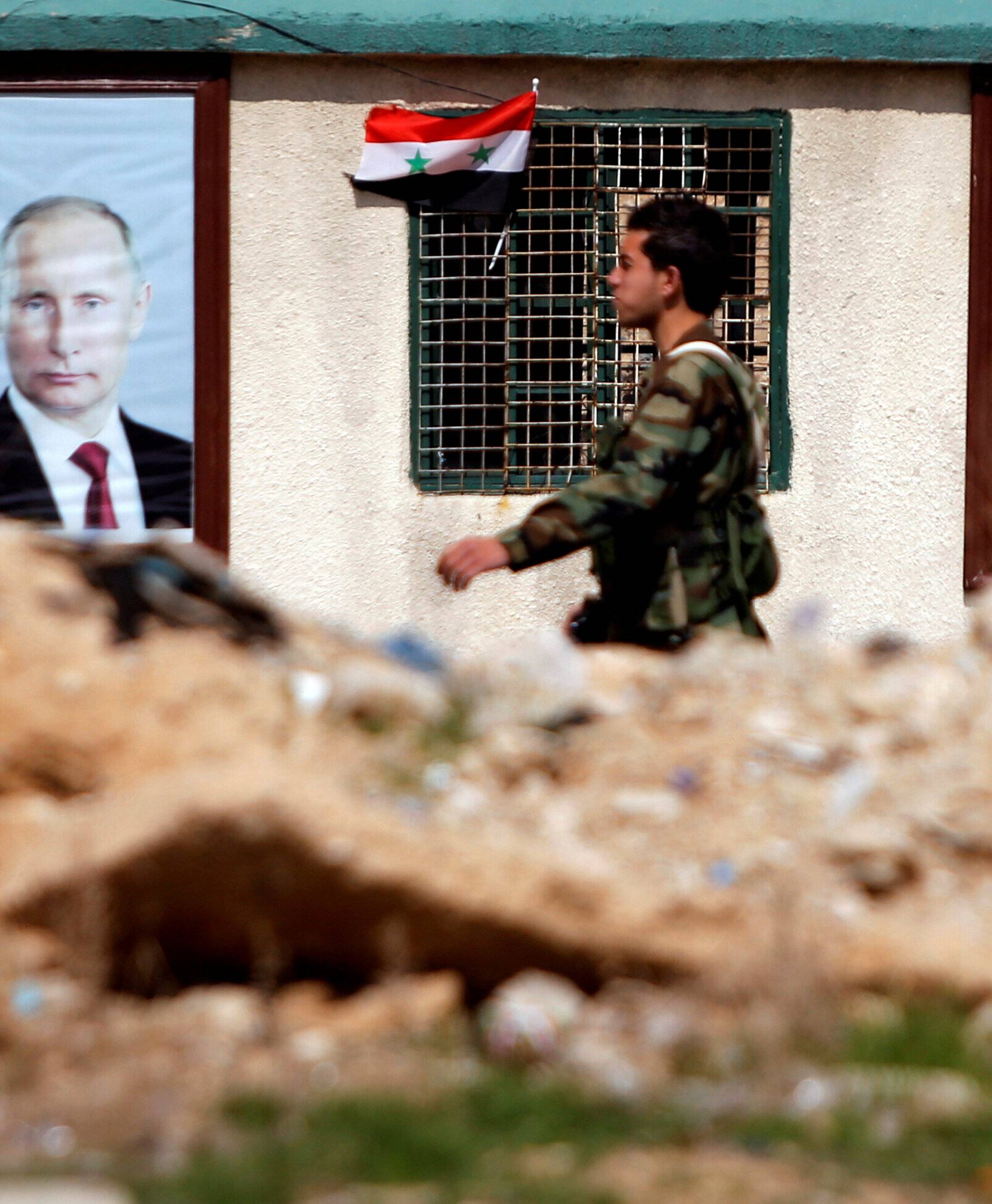FILE PHOTO: A Syrian soldier loyal to President Bashar al Assad is seen outside eastern Ghouta, in Damascus