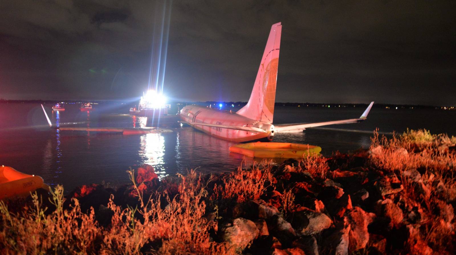 Boeing 737 aircraft  sits in shallow water of the St Johns River after it slid off the runway at Naval Air Station, Jacksonville, Florida