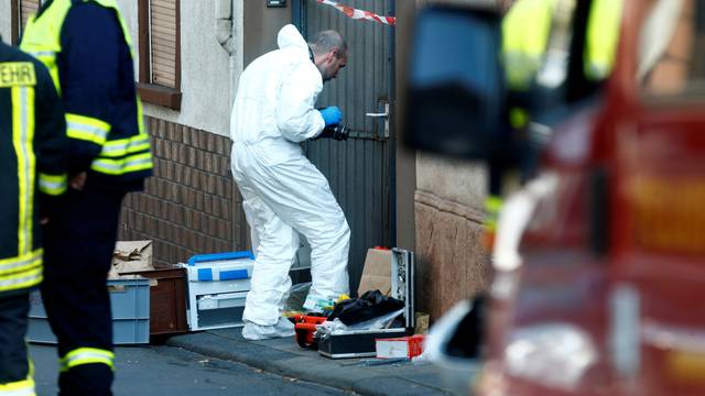 A forensic expert works at a crime scene where two people died during a police operation in Kirchheim