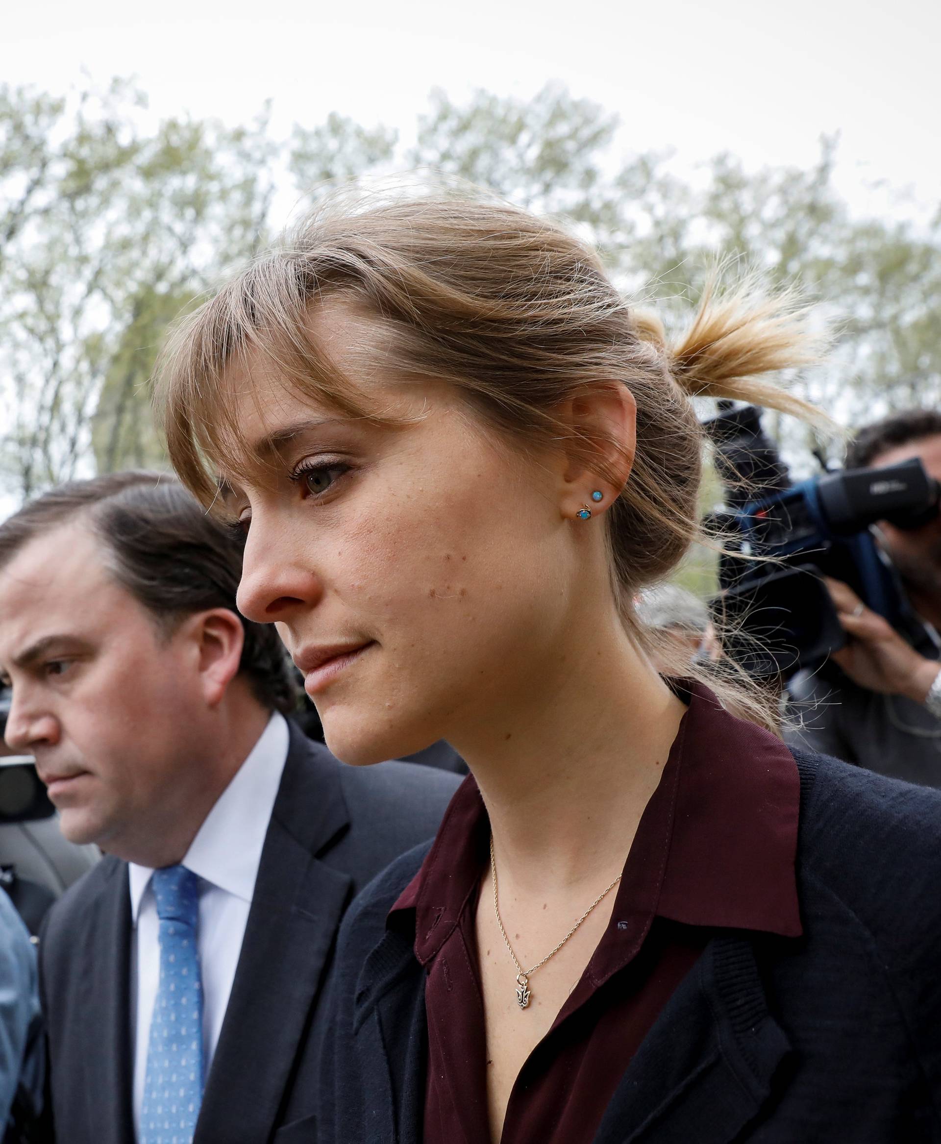 Actor Allison Mack, known for her role in the TV series 'Smallville', exits with her lawyer following a hearing on charges of sex trafficking in relation to the Albany-based organization Nxivm at United States Federal Courthouse in Brooklyn, New York
