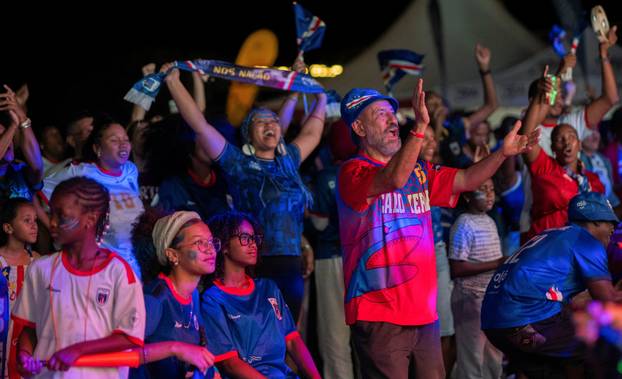 Fans of the Cape Verde national soccer team celebrate as they watch a World Cup group stage match against Uruguay in Praia