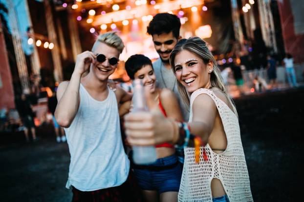 Group of friends having great time on music festival