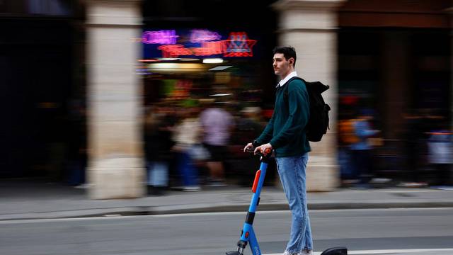 People ride electric scooters on the eve of a public vote to ban or not rental electric scooters in Paris