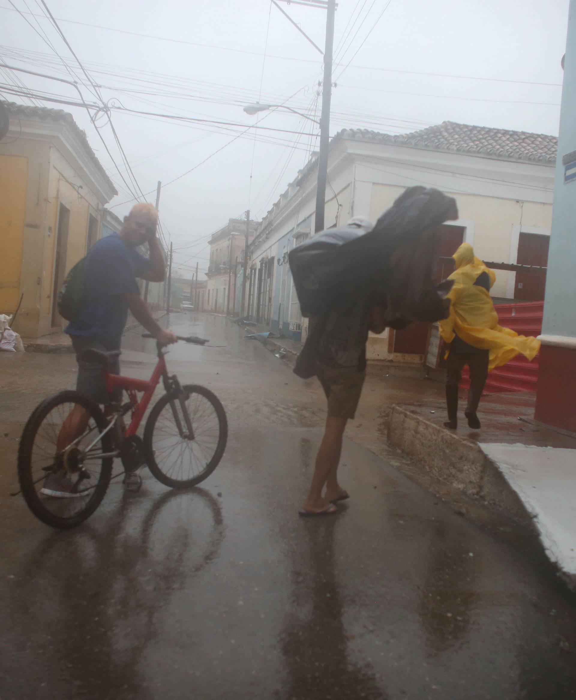 People walk on the street as Hurricane Irma passes by Remedios