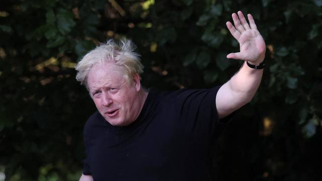 Former British Prime Minister Boris Johnson runs, in Brightwell-cum-Sotwell
