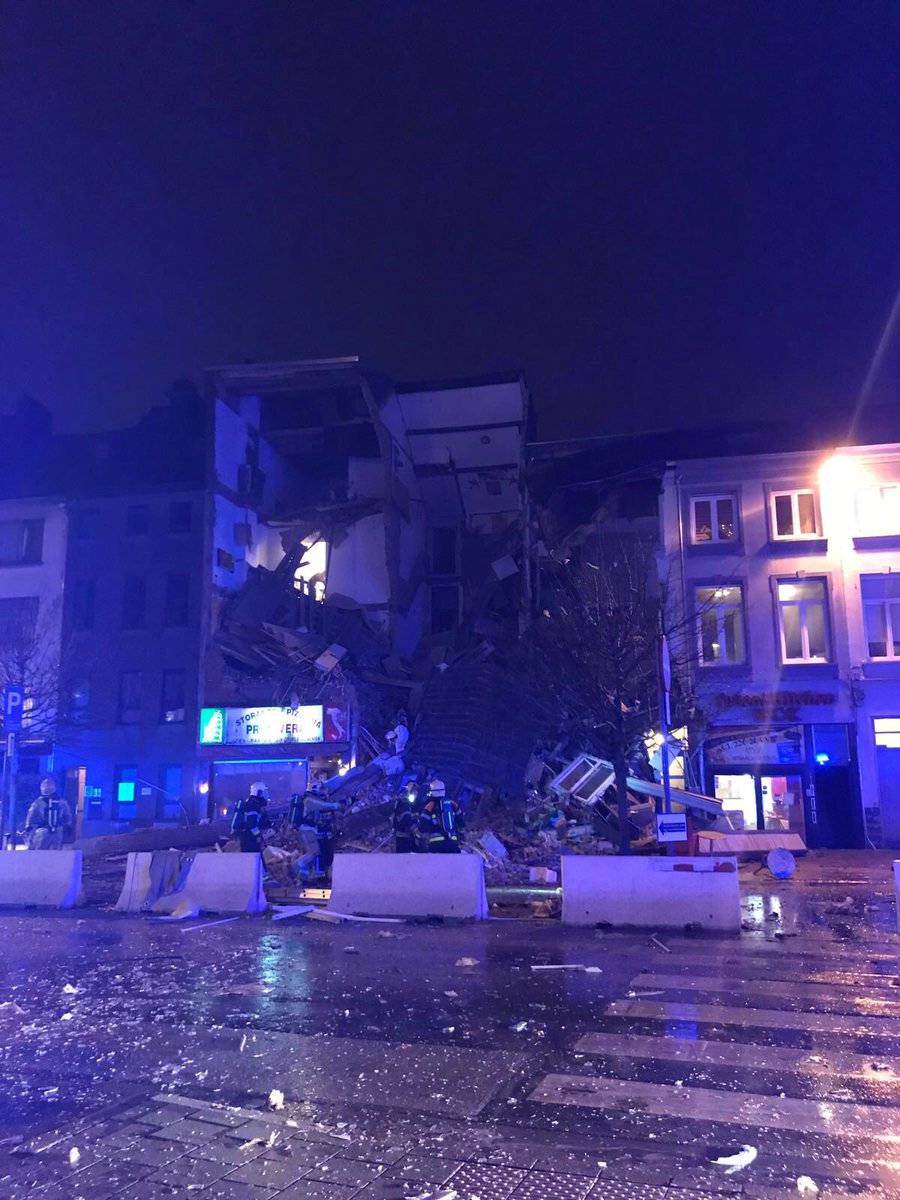 Emergency rescue personnel attend to the scene where a building has collapsed in Antwerp, Belgium