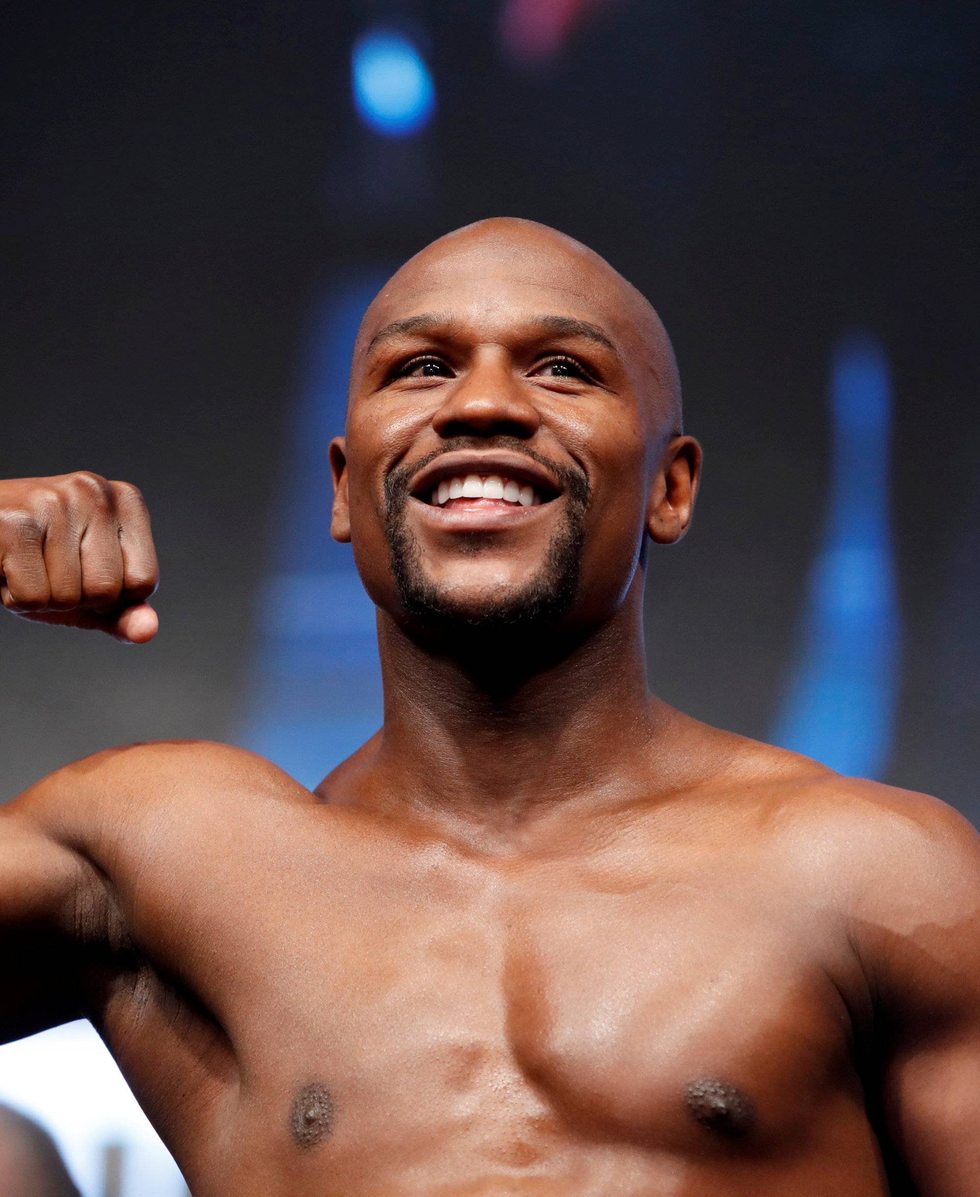 Undefeated boxer Floyd Mayweather Jr. of the U.S. poses on the scale during his official weigh-in at T-Mobile Arena in Las Vegas