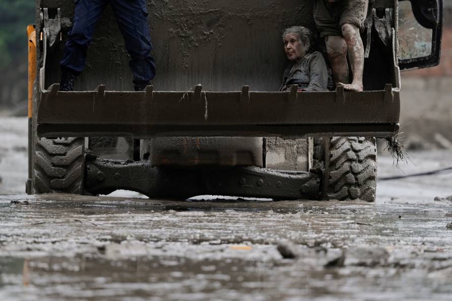 A survivor is transported to a safer place in a JCB following a flash flood at Trishuli, Nepal