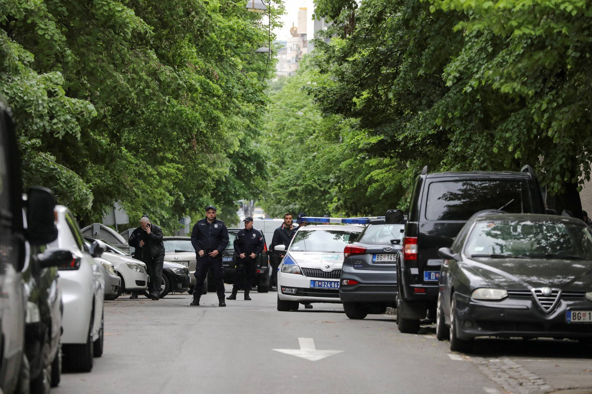 Police officers secure the area after a 14-year-old boy opened fire on other students and security guards at a school in downtown Belgrade