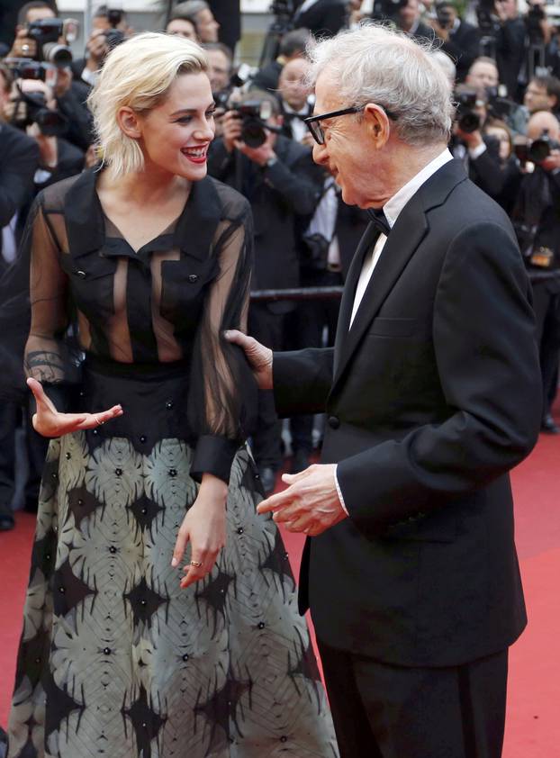 Director Woody Allen jokes with cast member Kristen Stewart on the red carpet as they arrive for the opening ceremony and the screening of the film "Cafe Society" out of competition during the 69th Cannes Film Festival in Cannes