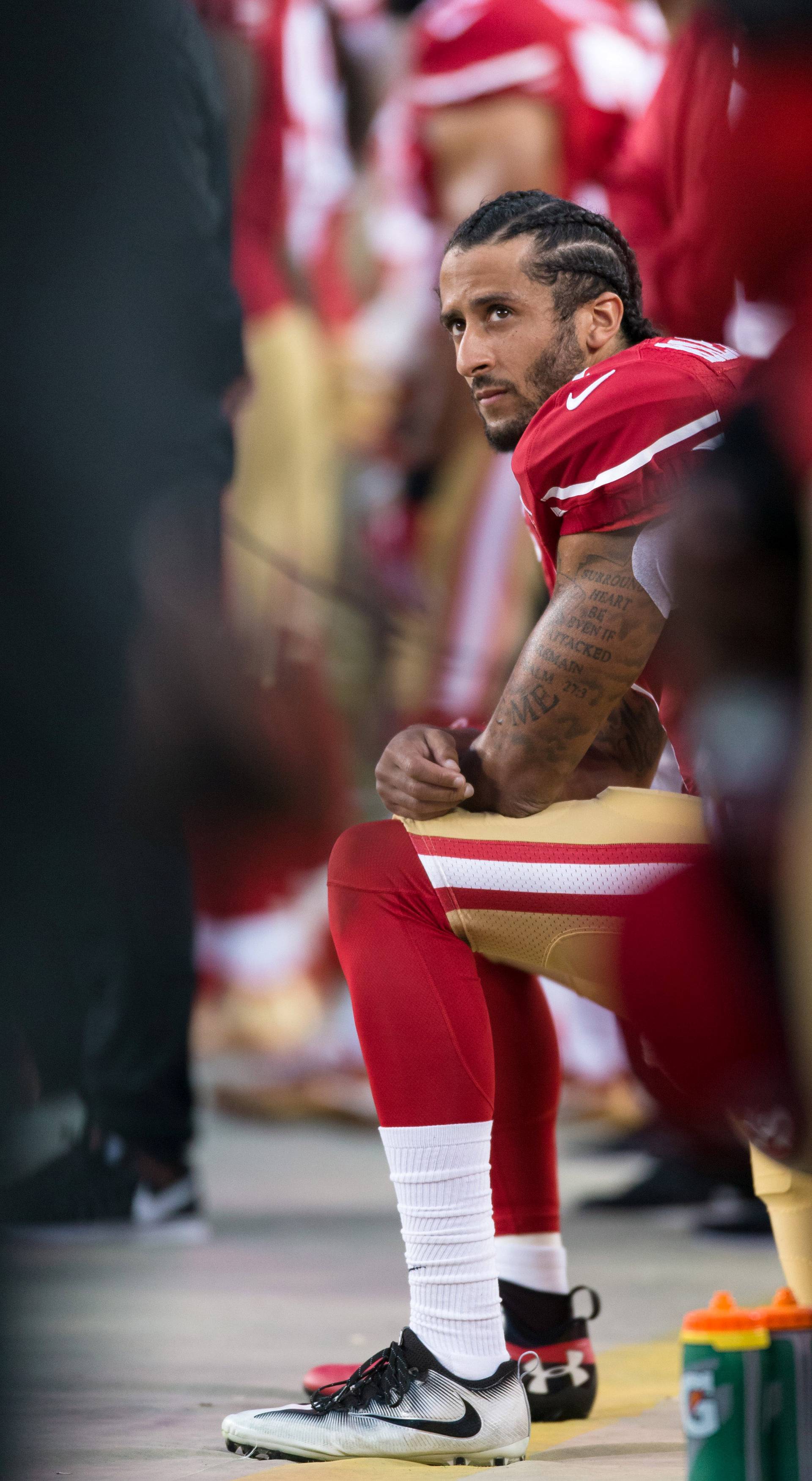 FILE PHOTO: San Francisco 49ers quarterback Colin Kaepernick (7) sits during the national anthem in Santa Clara