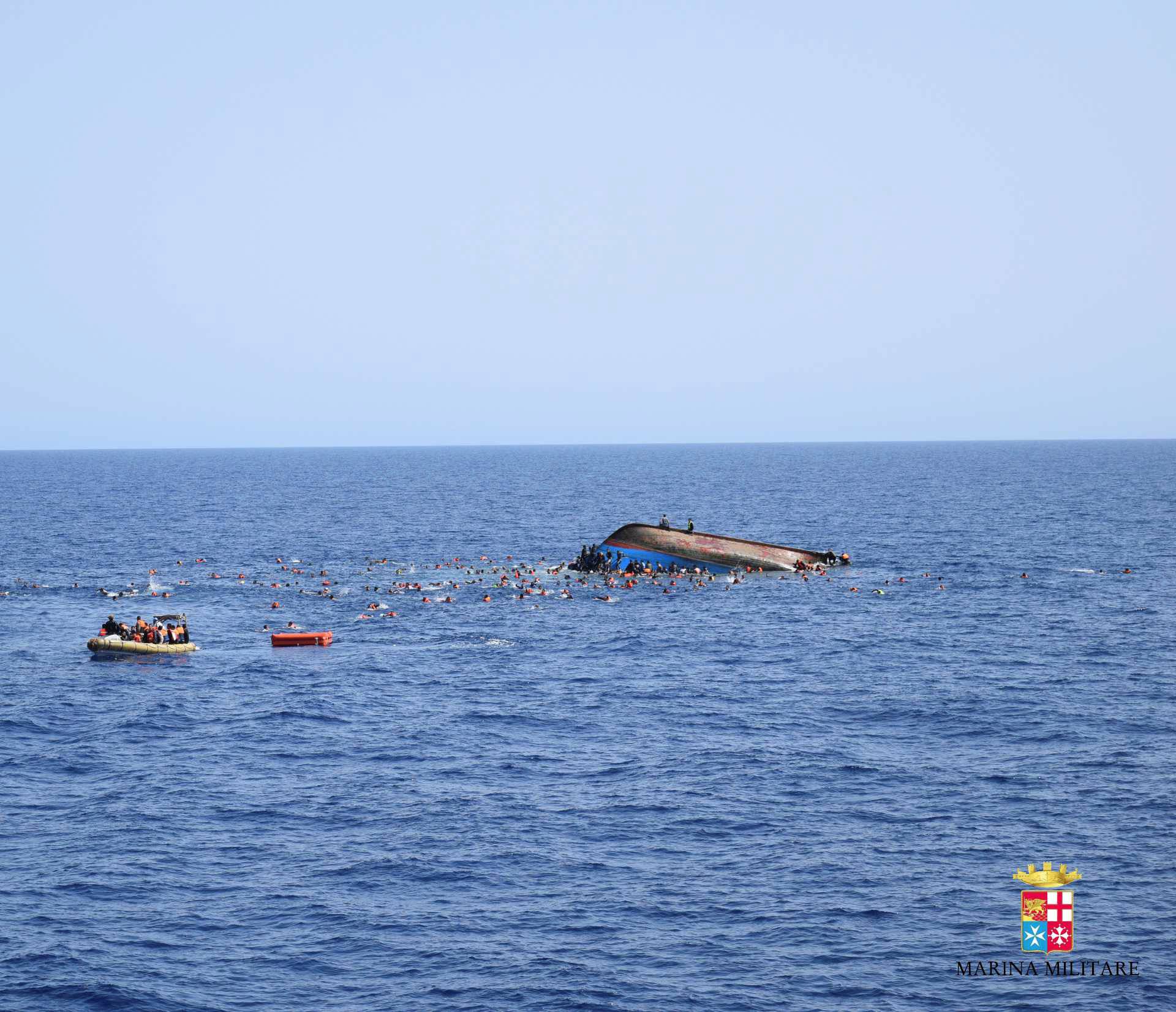 Migrants are rescued from a capsized boat during a rescue operation by Italian navy ships "Bettica" and "Bergamini" off the coast of Libya