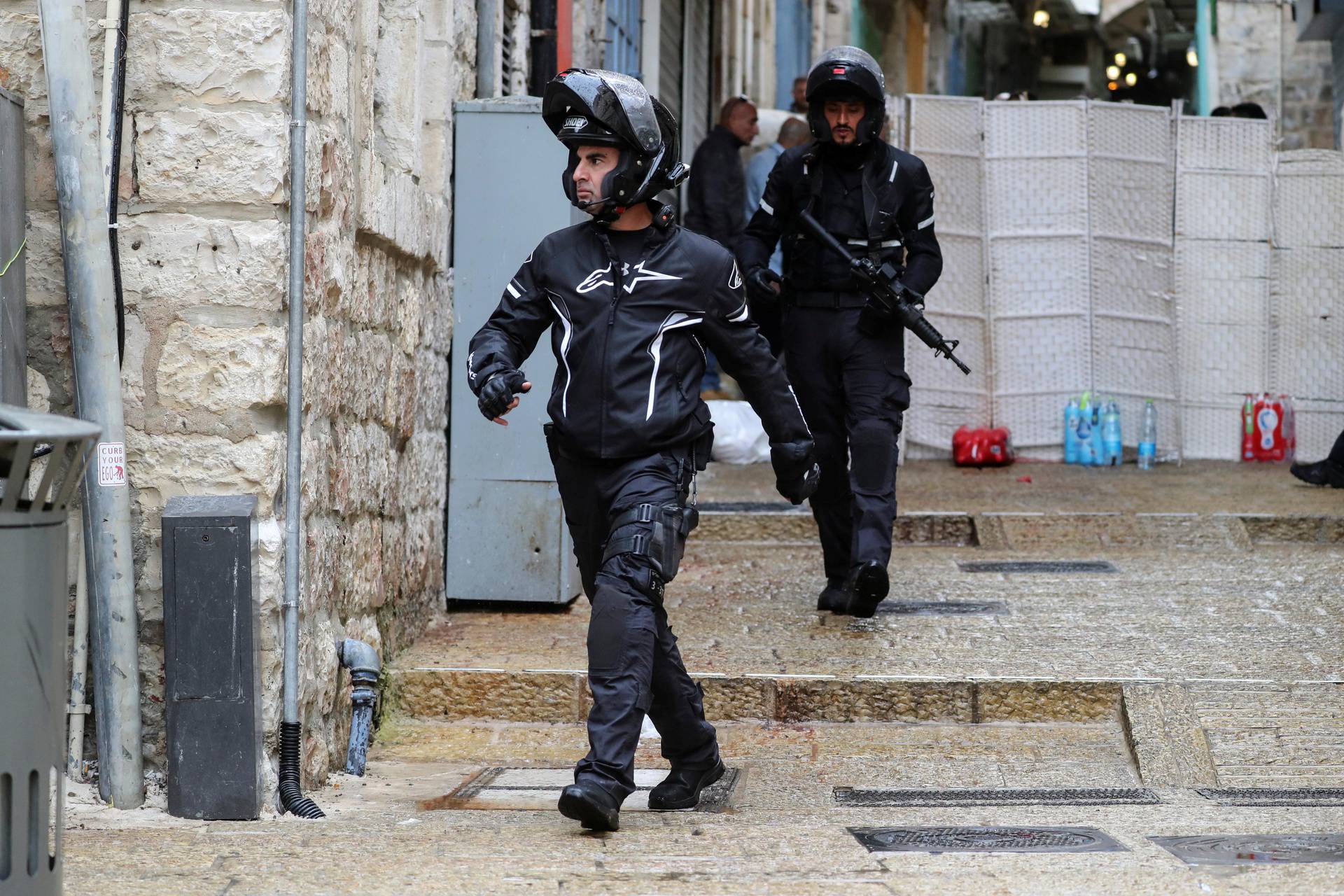 Israeli police officers patrol the site of a shooting incident in Jerusalem's Old City