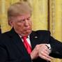 FILE PHOTO: U.S. President Trump checks his watch during an event in the East Room of the White House in Washington, D.C.