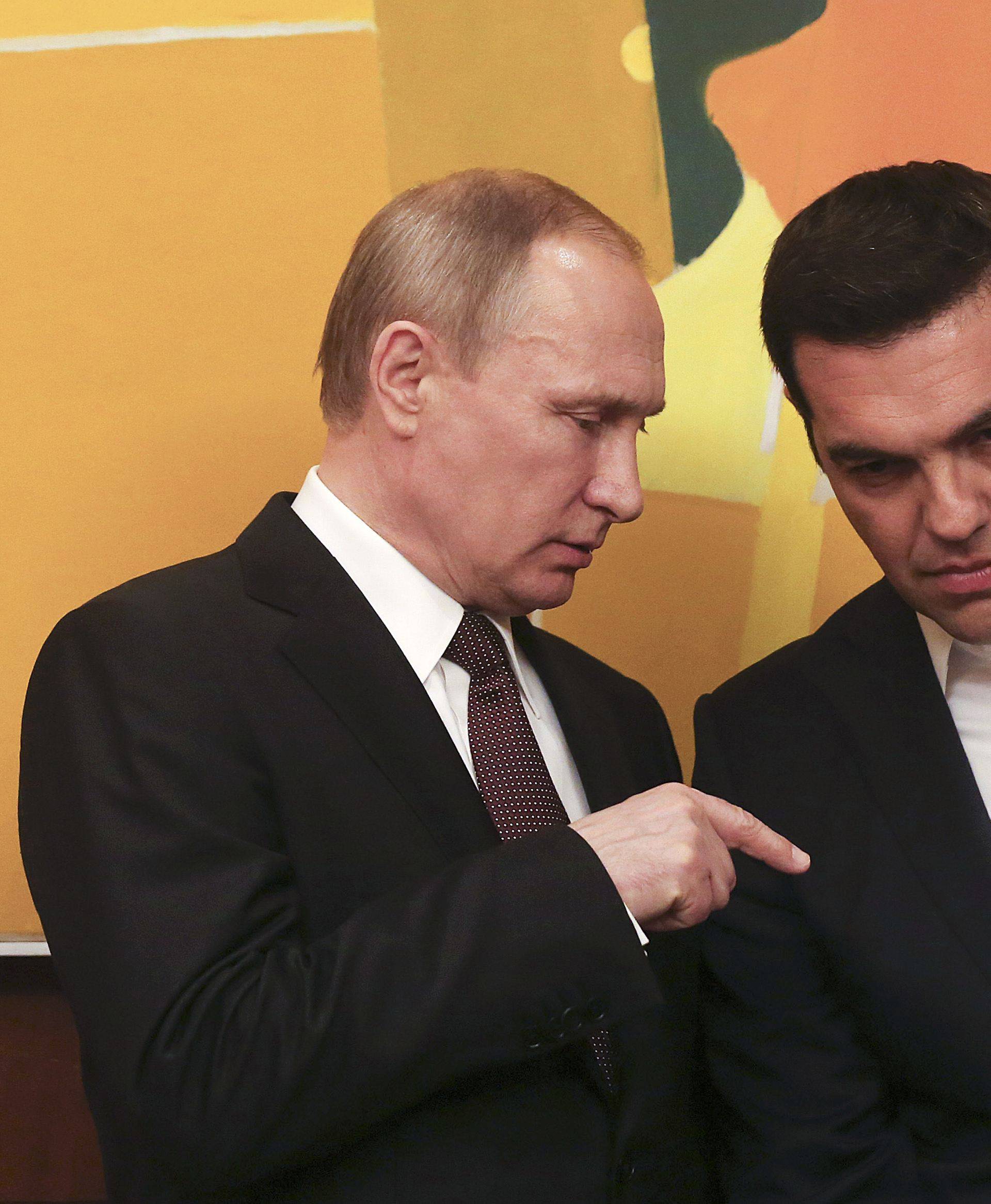 Greek PM Tsipras talks with Russian President Putin during their meeting in Athens