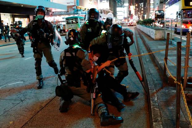 Riot police detain an anti-government protester during a protest at Mong Kok, in Hong Kong