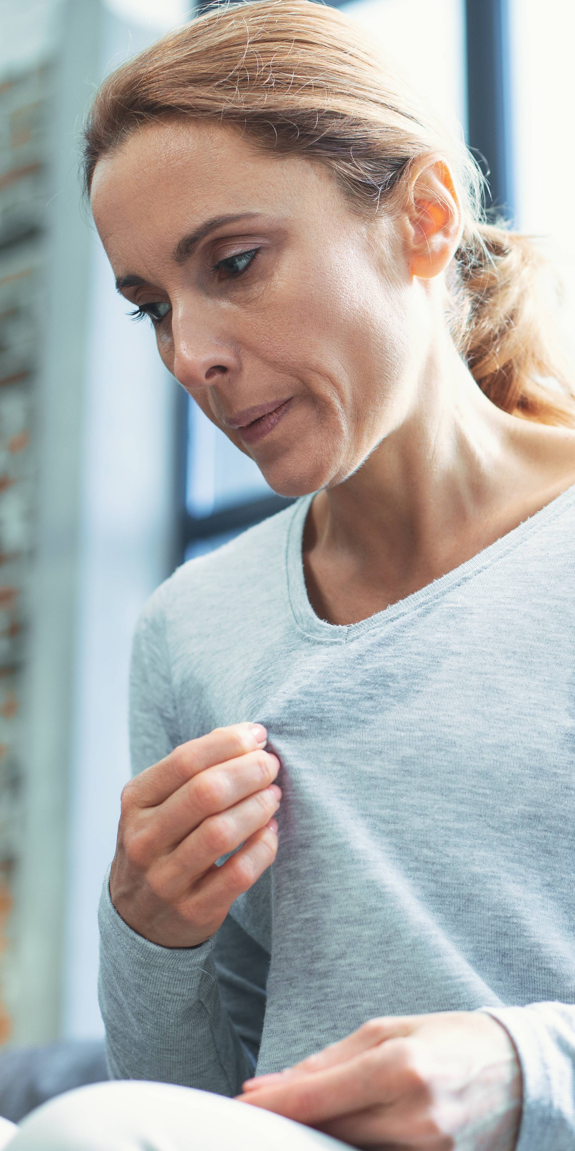 Exhausted mature woman entering menopause