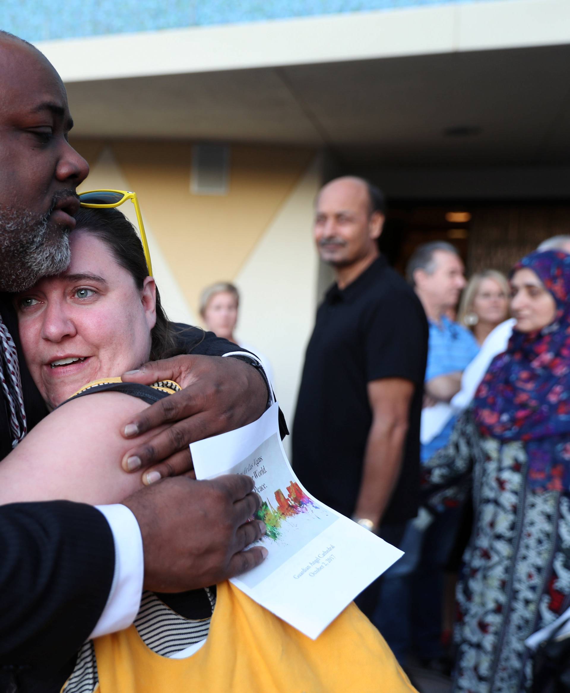 People mourn after an interfaith memorial service for victims of the Route 91 music festival mass shooting outside the Mandalay Bay Resort and Casino in Las Vegas