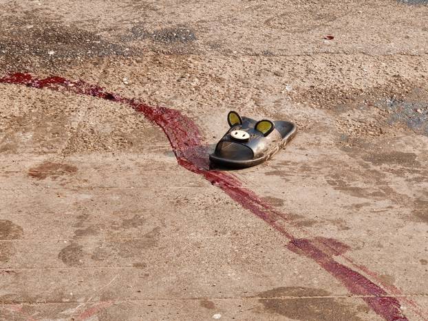 Trace of blood and a shoe are seen where an injured protester was carried to safety during protests against the military coup, in Hlaing township in Yangon