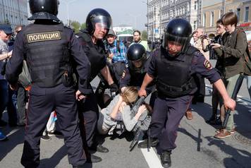 Policemen detain opposition supporters during a protest ahead of President Vladimir Putin's inauguration ceremony, Moscow