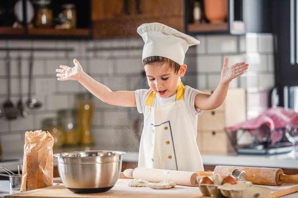 Toddler,Boy,Playing,With,The,Dough,In,The,Kitchen,Dressed