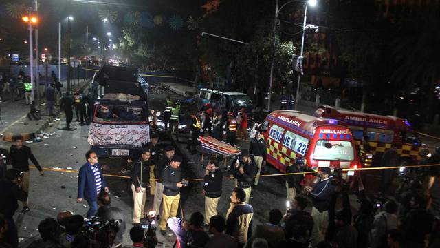 Police and rescue workers work at the scene of a blast in Lahore