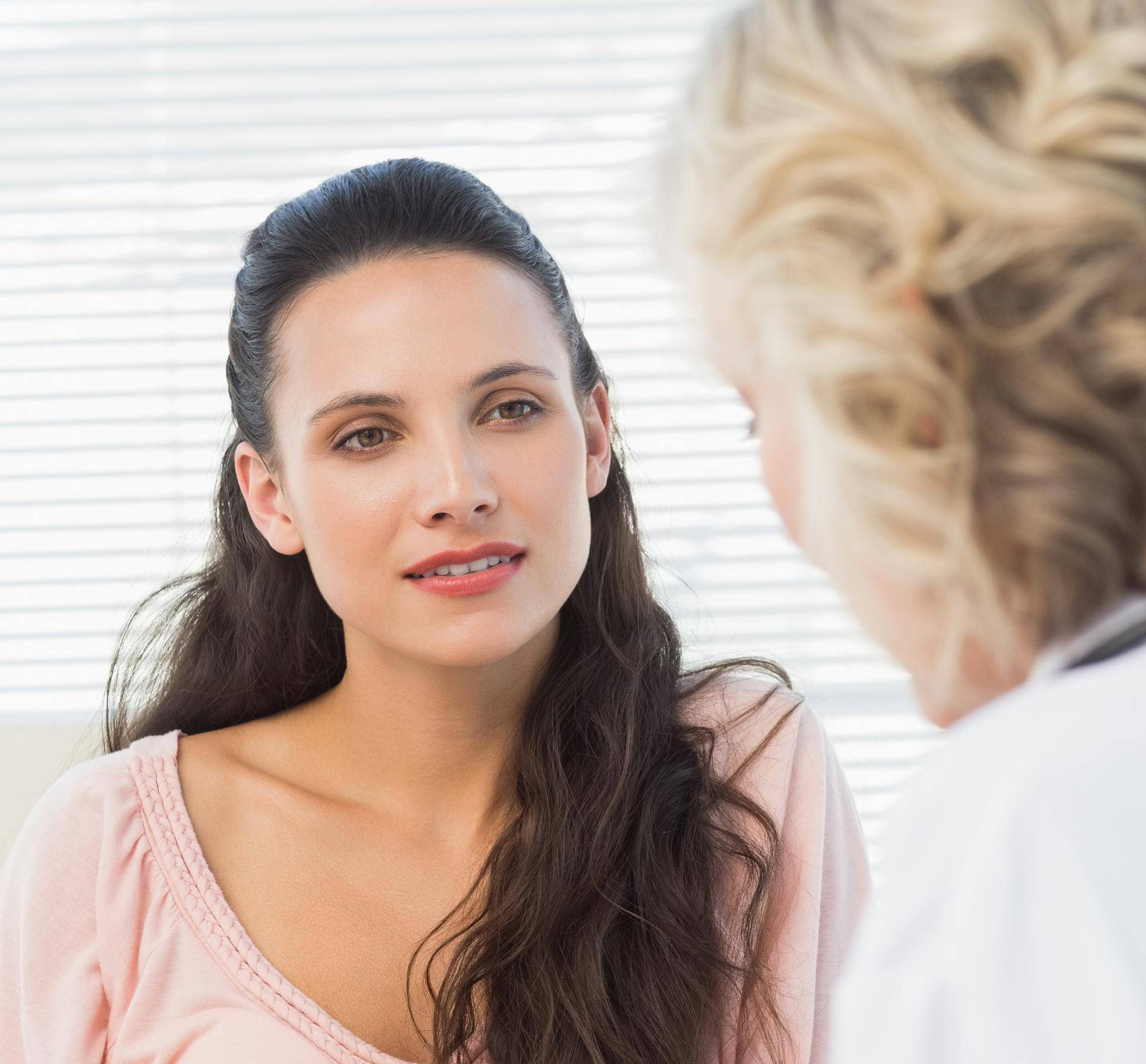 Female patient listening to doctor with concentration