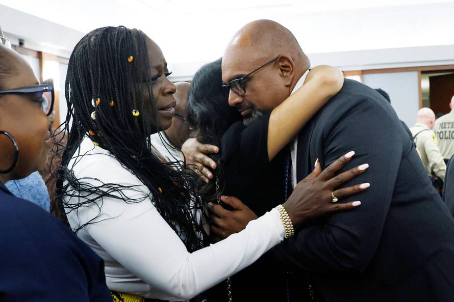 Friends and family members of rapper Tupac Shakur line up to hug Chief Deputy District Attorney Binu Palal, after a jury found Duane Davis guilty in the 1996 killing of Tupac Shakur
