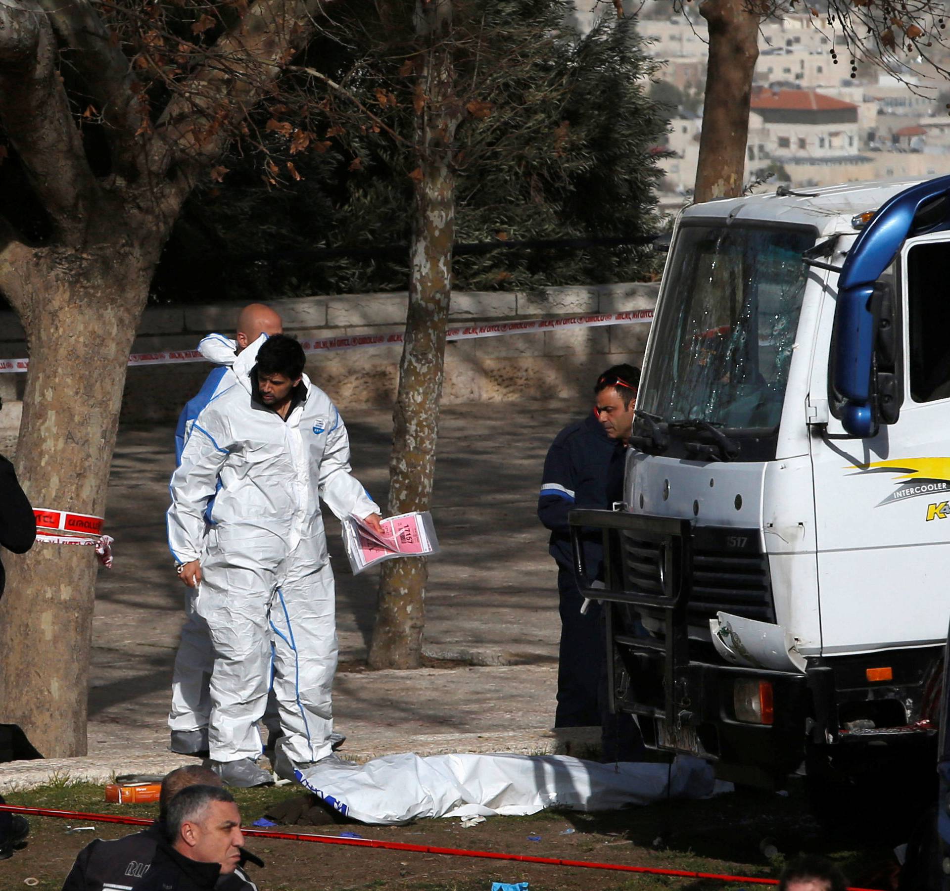 Israeli security and rescue forces work at the scene of a truck ramming incident in Jerusalem