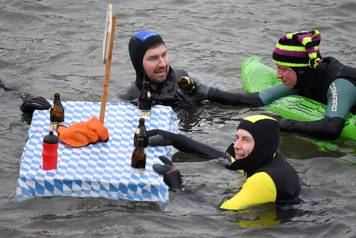 Swimmers wearing costumes bathe in the 3 degrees Celsius water of the river Danube during their annual 4 km swim, in Neuburg an der Donau