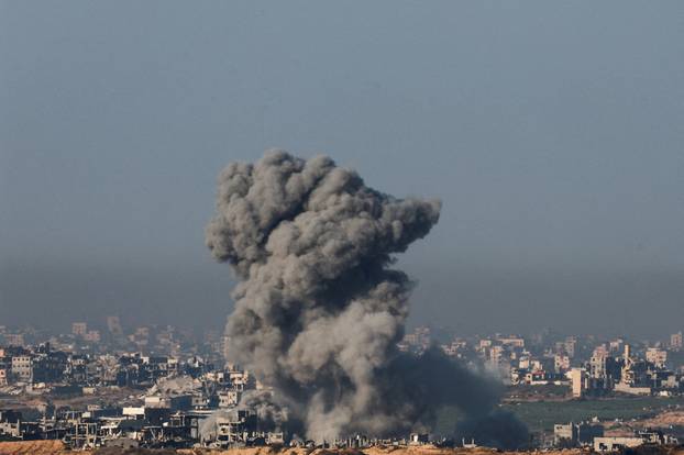 Smoke billows as buildings lie in ruin in the Gaza Strip, amid the ongoing conflict between Israel and Hamas, as seen from southern Israel