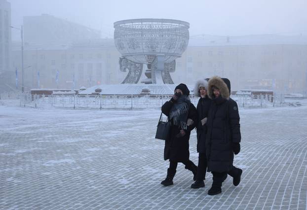 People walk across a square on a frosty day in Yakutsk