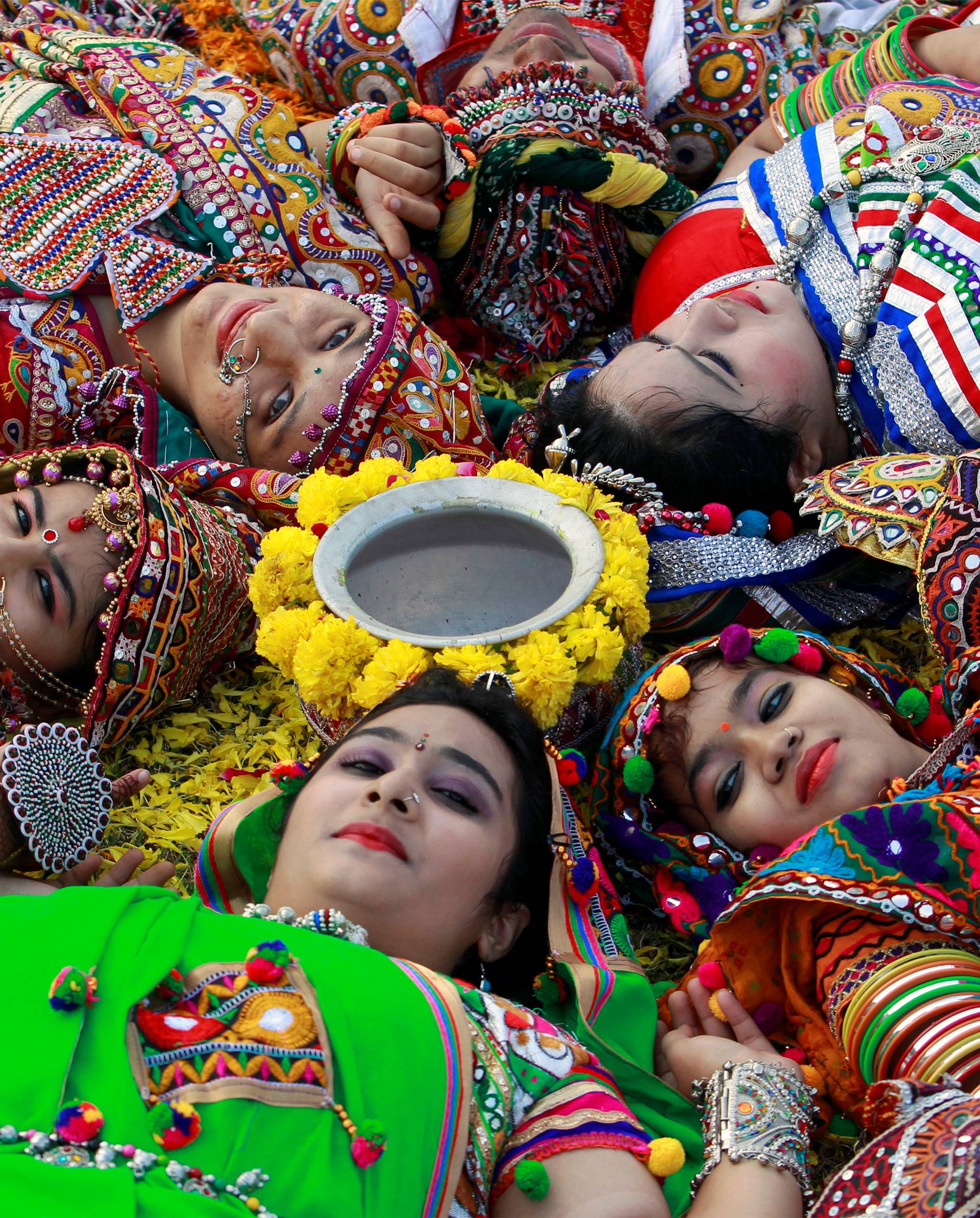 Participants dressed in traditional attire pose during rehearsals for Garba, a folk dance, ahead of Navratri in Ahmedabad