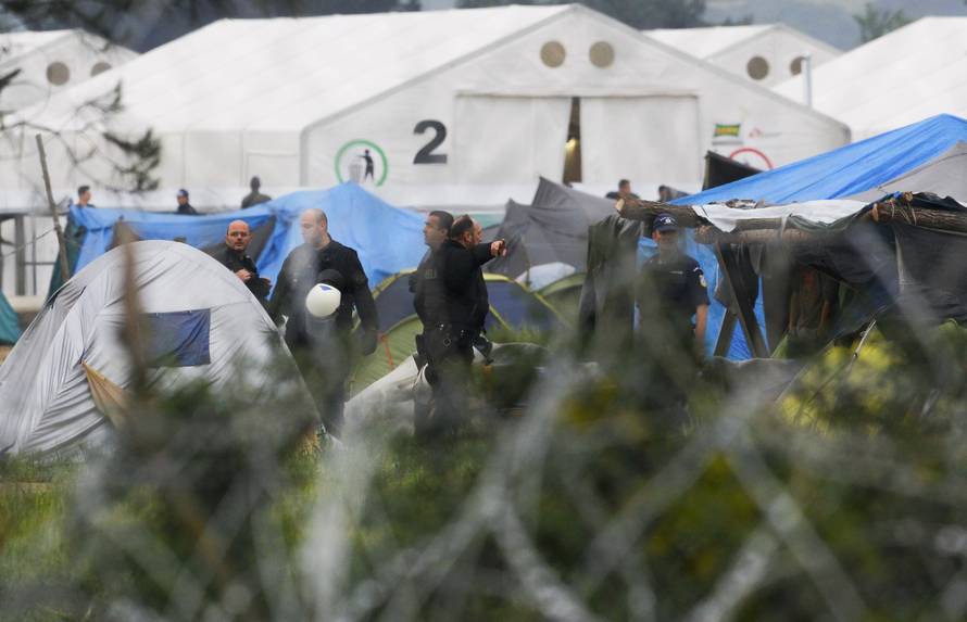 Greek policemen operate at a makeshift camp for migrants and refugees at the Greek-Macedonian border near the village of Idomeni