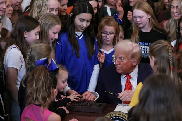 U.S. President Donald Trump signs an executive order banning transgender girls and women from participating in women's sports, at the White House