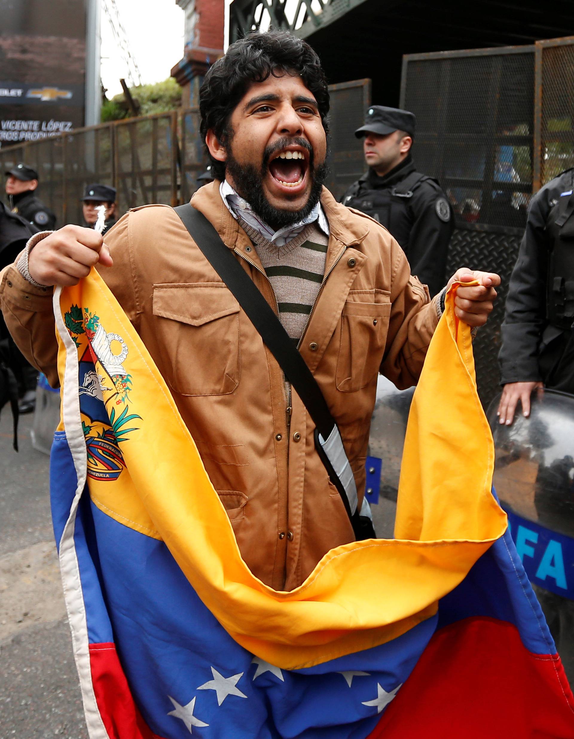 A Venezuelan resident takes part in a protest near Venezuela's Embassy in Argentina in support of the rally demanding a referendum to remove Venezuela's President Nicolas Maduro, in Buenos Aires