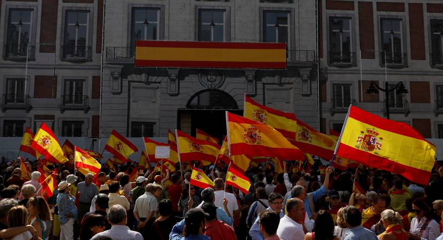 Demonstrators wave Spanish flags during a demonstration in favor of a unified Spain on the day of a banned independence referendum in Catalonia, in Madrid