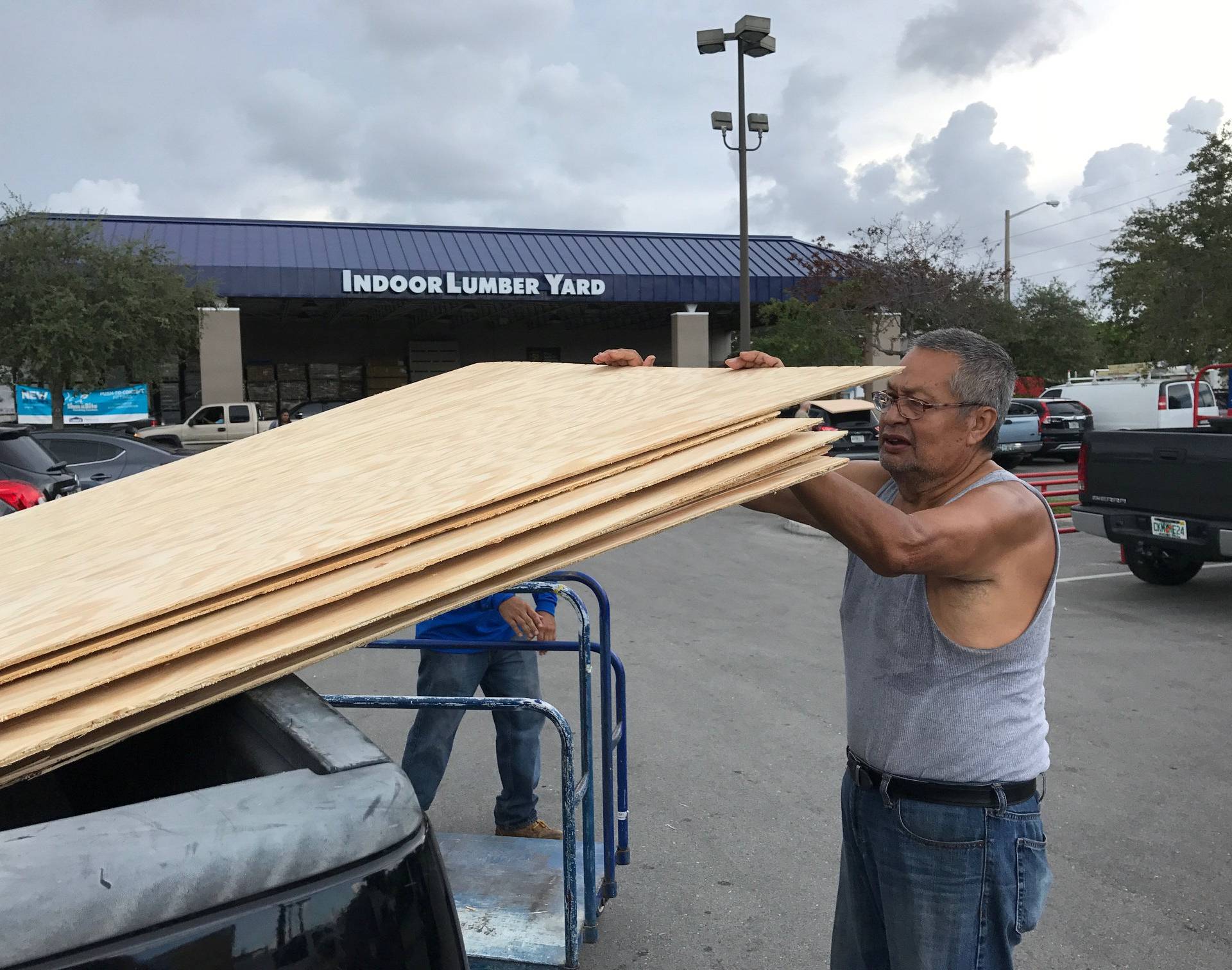 Jerry Garcia loads one of the 20 sheets of plywood he is taking home to prepare for Hurricane Irma at a home supply store in Oakland Park